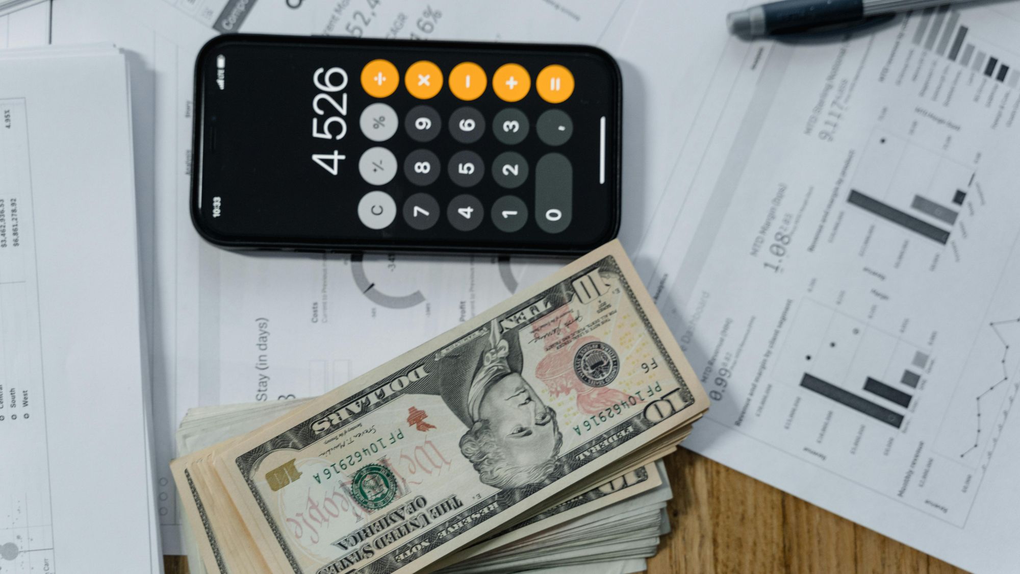 A stack of dollars and a calculator showing e-commerce bookkeeping and reconciliation errors